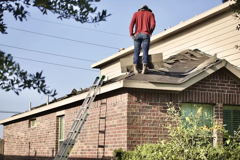 Professional roofer working on a residential roof in Heritage Place
